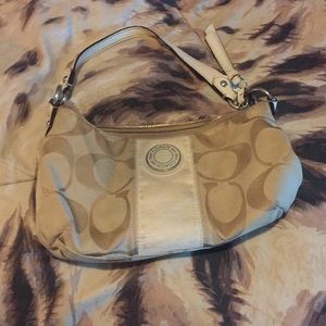 Cream colored little Coach purse